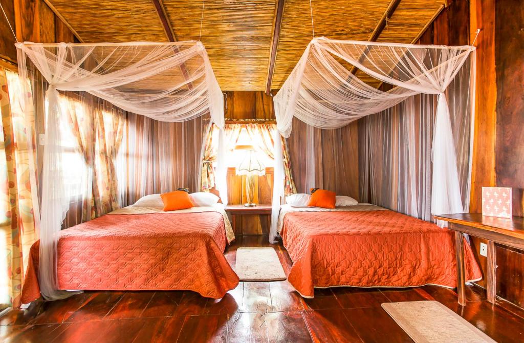 MechapaRedwood Beach Resort的一间卧室配有两张床和窗帘