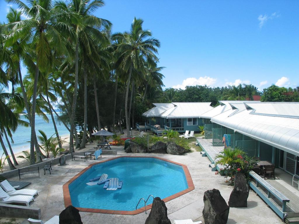 拉罗汤加日天堂海滩简易别墅酒店的海滩旁带游泳池的度假村
