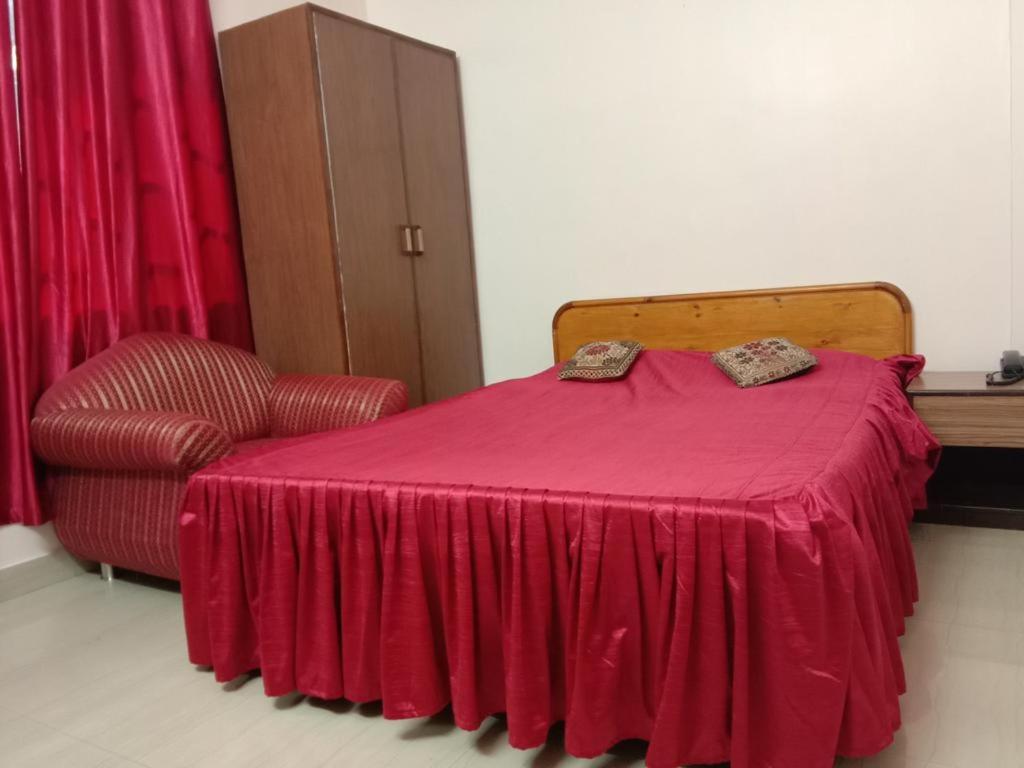 西隆Hotel Heritage的一间卧室配有红色的床和椅子