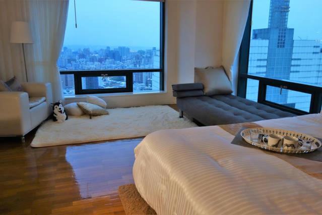 台中市行草景观公寓的客厅配有床和沙发