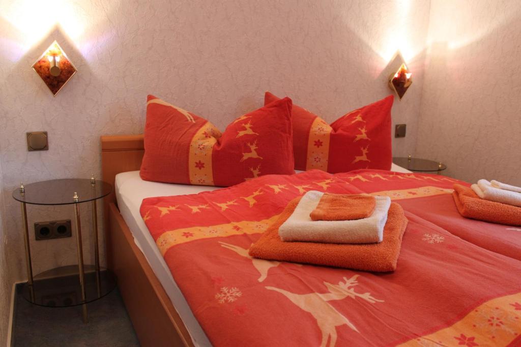 韦尼格罗德普本斯图伯钦公寓的一间卧室配有红色的床和红色枕头