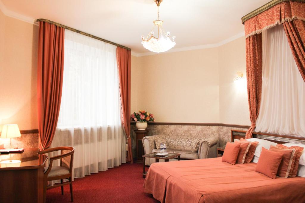 伊尔库茨克帝国酒店 的酒店客房设有床、沙发和窗户。