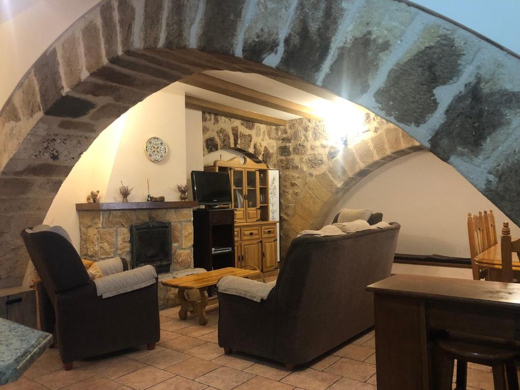 奥尼亚Casa De La Juderia的客厅配有两把椅子和壁炉