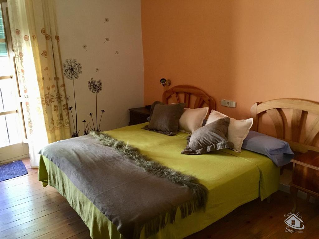 锡古恩萨Casa Tere的一间卧室配有带枕头的绿色床