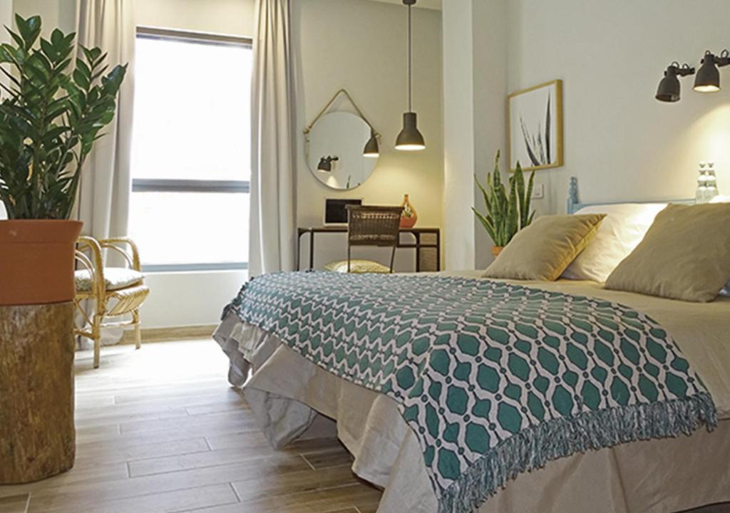 阿尔坎塔里利亚Vicente Home的一间卧室配有一张床、一张桌子和一个窗户。
