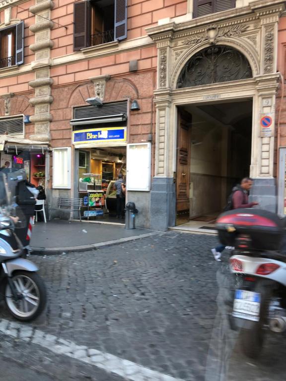 罗马Ottaviano Lodge的摩托车停在大楼前的街道上