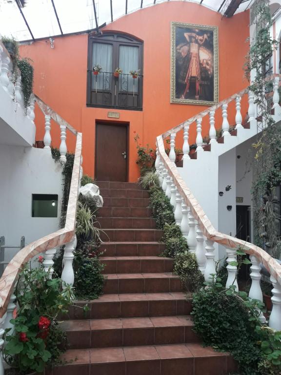 波托西图克斯拉皇家金堡旅馆的通往一座拥有橙色墙壁的建筑的楼梯