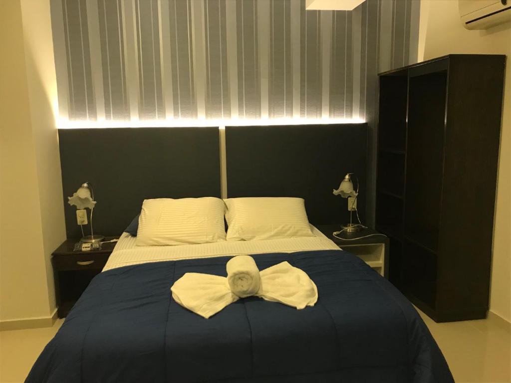 恩卡纳西翁德里奥公寓酒店 的一间卧室,配有一张床,床上有一个弓