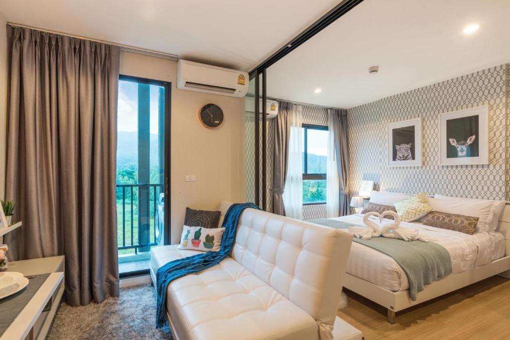 邦涛海滩Bangtao,Layan beach apartment的卧室配有白色的床和沙发
