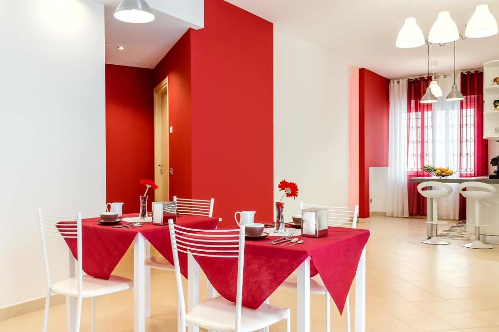 罗镇Villa Rosina的红色的饭厅,配有红色的桌子和椅子