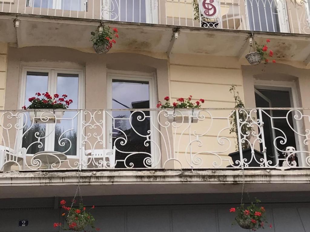 普隆比埃莱班Carpe Diem Résidence的花在上面的建筑的阳台