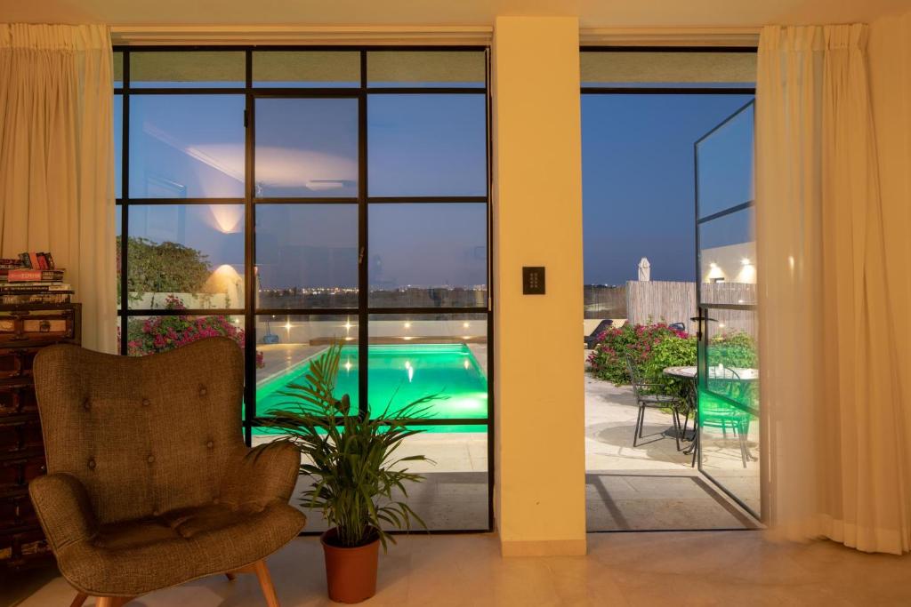 Giv'ot BarDesertB的客厅享有游泳池的景致,可通过滑动玻璃门看到。