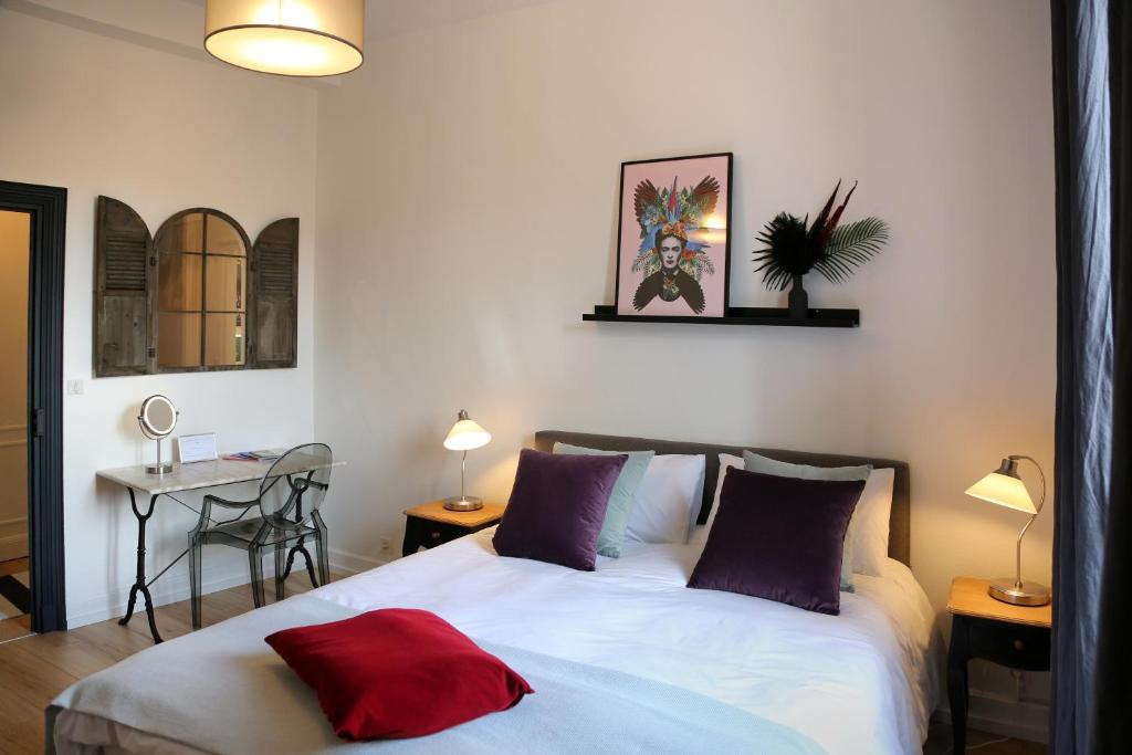 卡奥尔Troisième Droite的一间卧室配有一张红色枕头的床