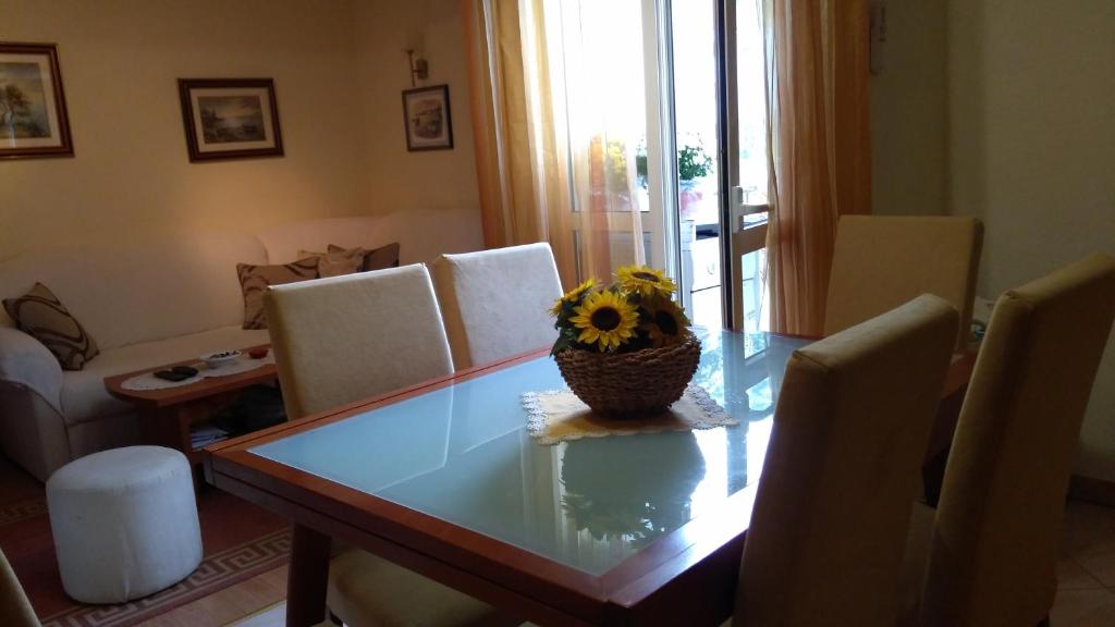 维斯Apartment Tatjana的餐桌,带花瓶,上面有向日葵