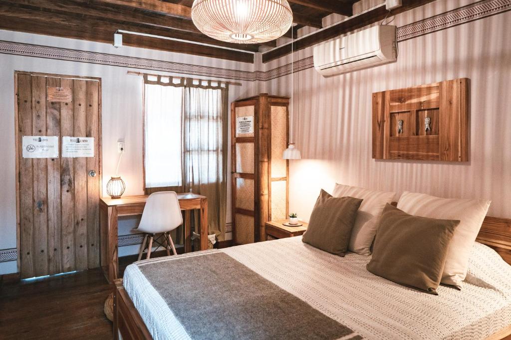蒙塔尼塔蒂基凌波酒店的一间卧室配有一张床、一张桌子和一把椅子