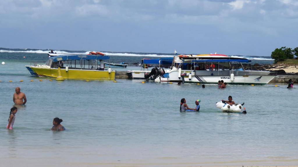 马埃堡Sacha Tourist Residence 2的一群人,在船边的水里