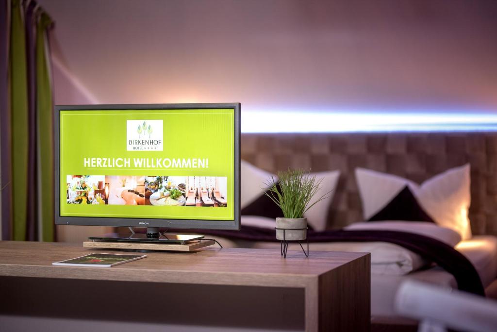 巴特索登-萨尔明斯特比肯霍夫餐厅酒店的卧室里的桌子上电视机