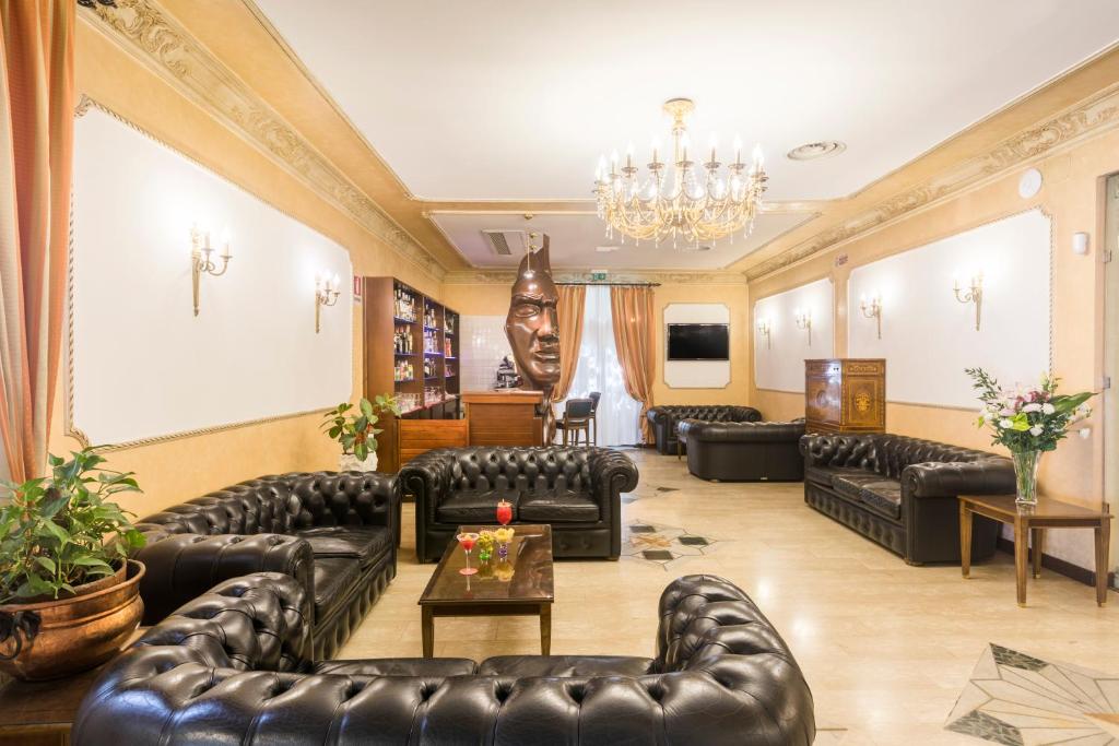 罗马罗莎别墅酒店的客厅配有皮革家具和吊灯。