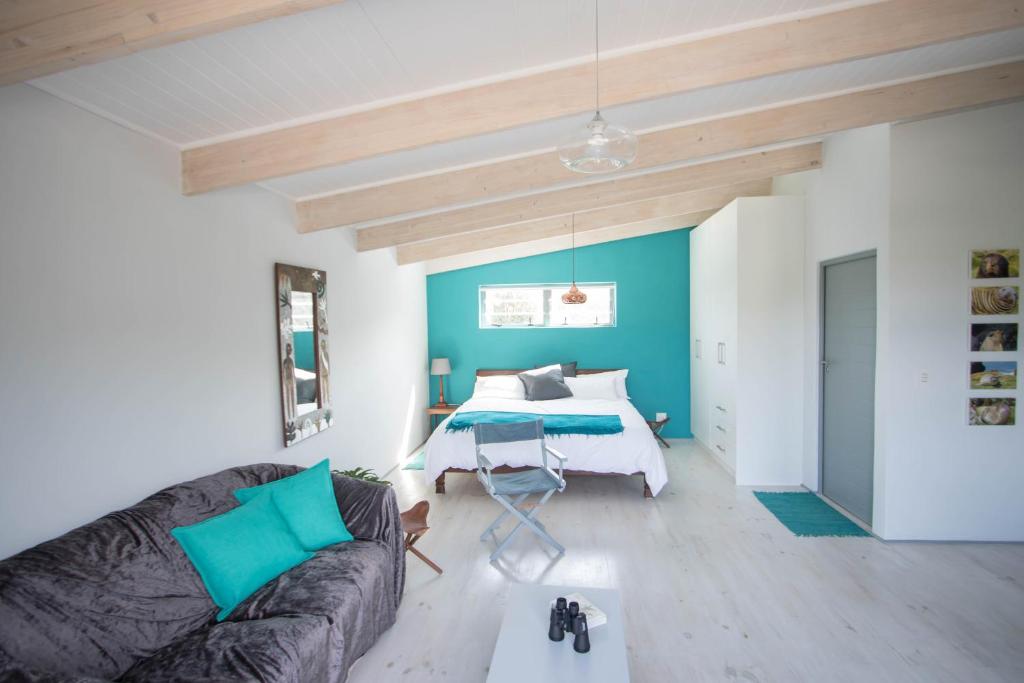 努尔德霍克Selkie - Two Restful Studio Apartments near Noordhoek Beach & Restaurants的客厅配有沙发和1张床