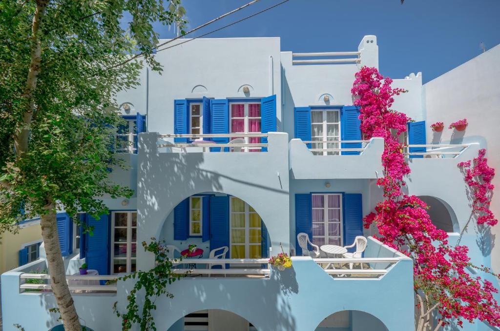 纳克索乔拉加拉兹雅公寓的白色的建筑,有蓝色的窗户和鲜花