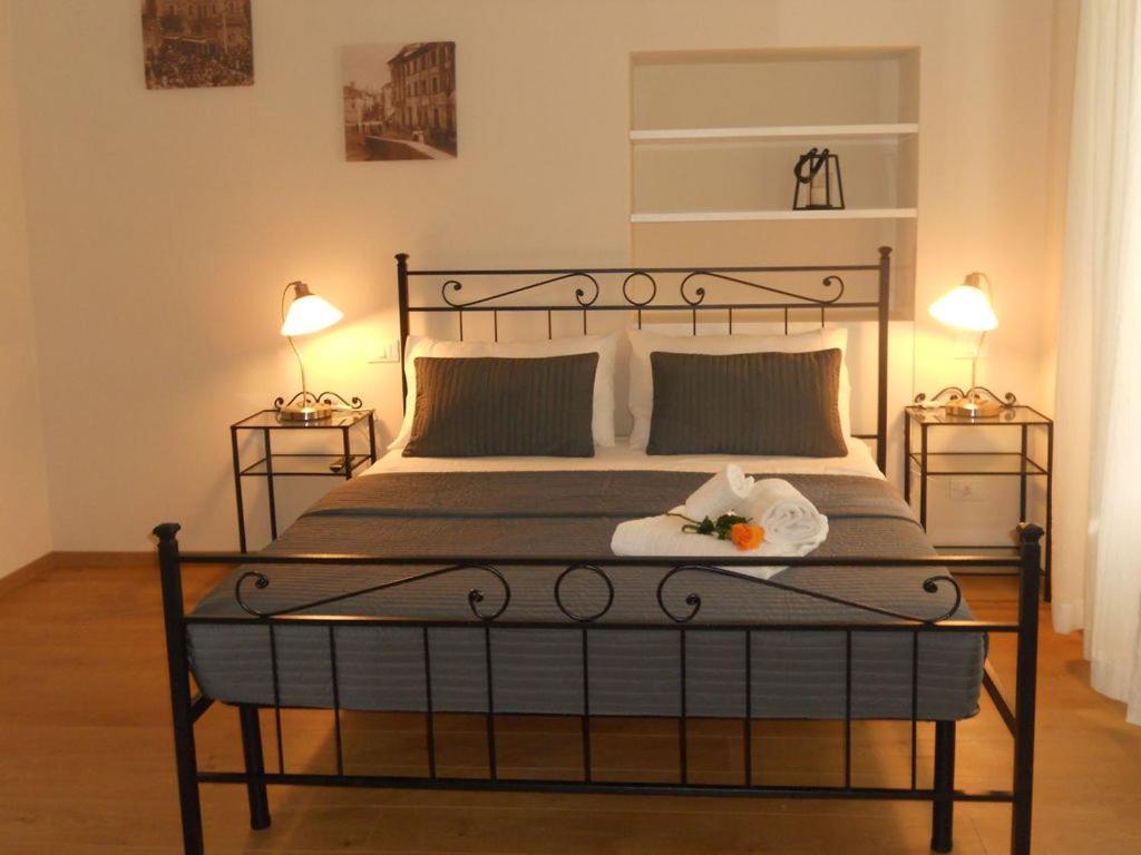 彼得拉桑塔Appartamento URANIA - LE MUSE的一间卧室配有一张大床和两盏灯