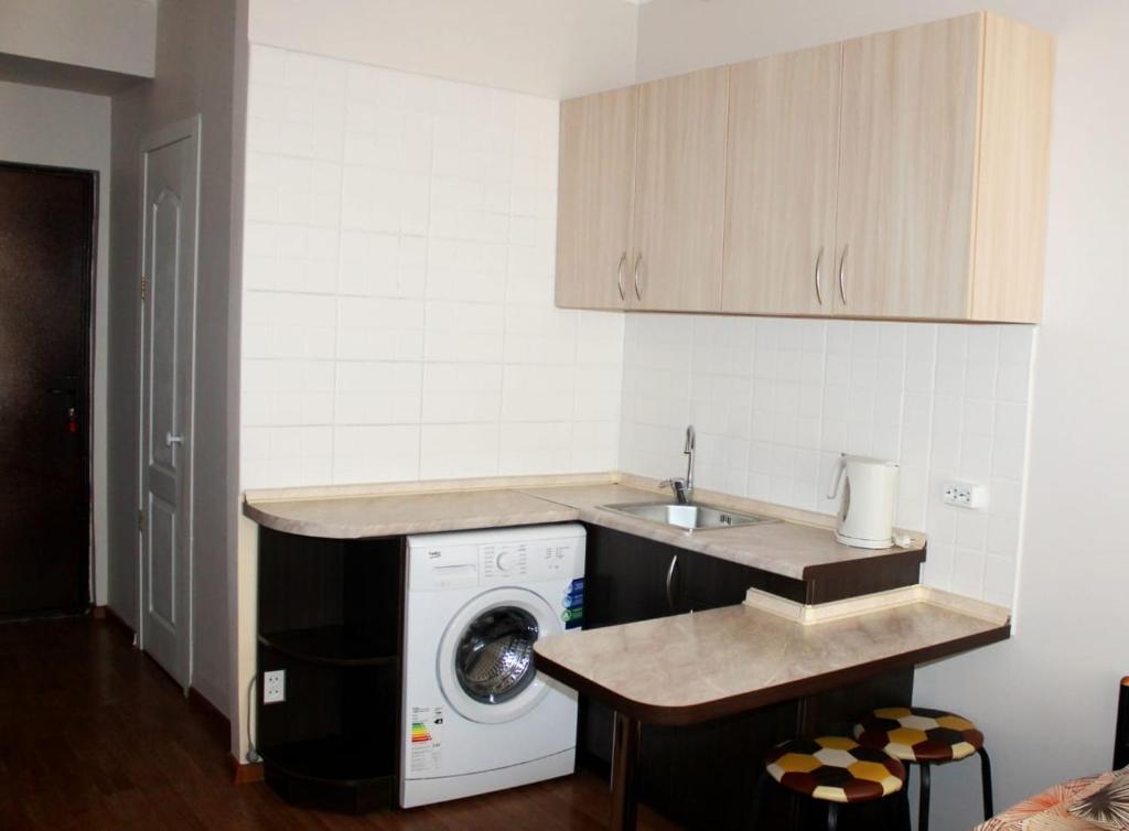 阿拉木图Apartments Zhambyl 159的厨房配有洗衣机和水槽