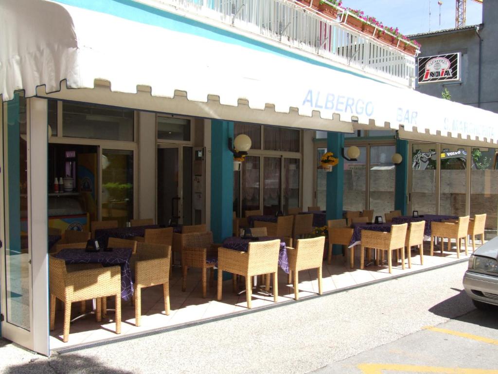 卡奥莱Albergo Santa Margherita的街边设有桌椅的餐厅
