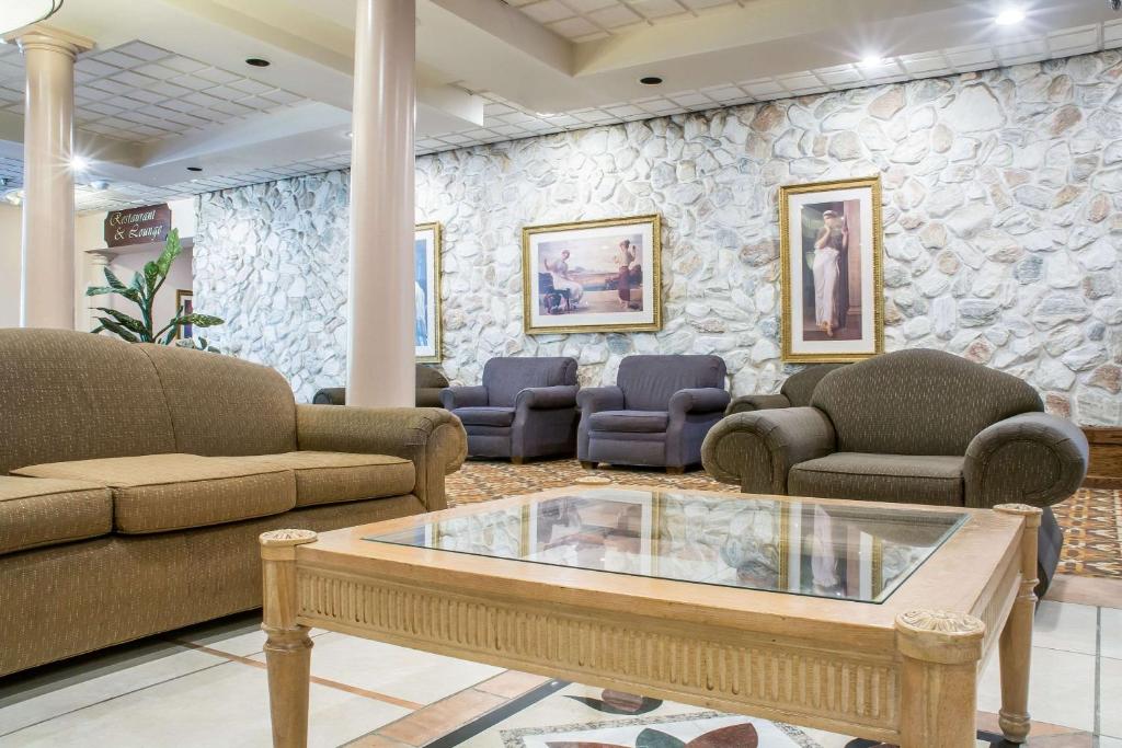 巴达维亚棕榈岛室内水上公园品质酒店套房的一间配有沙发和石墙的等候室