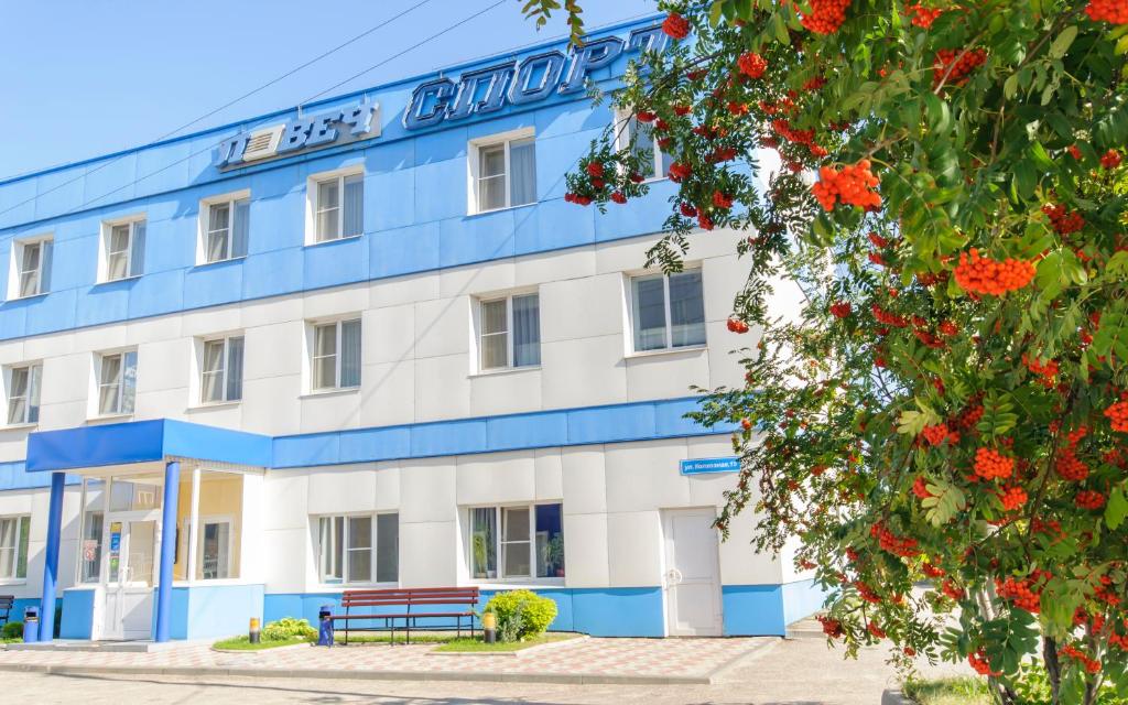 梁赞洛维奇体育酒店的前面有长凳的蓝色和白色建筑