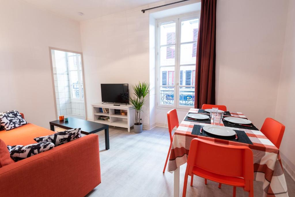 波城Appartement cœur de ville - Wifi - Lave-sèche linge的客厅配有桌椅和沙发