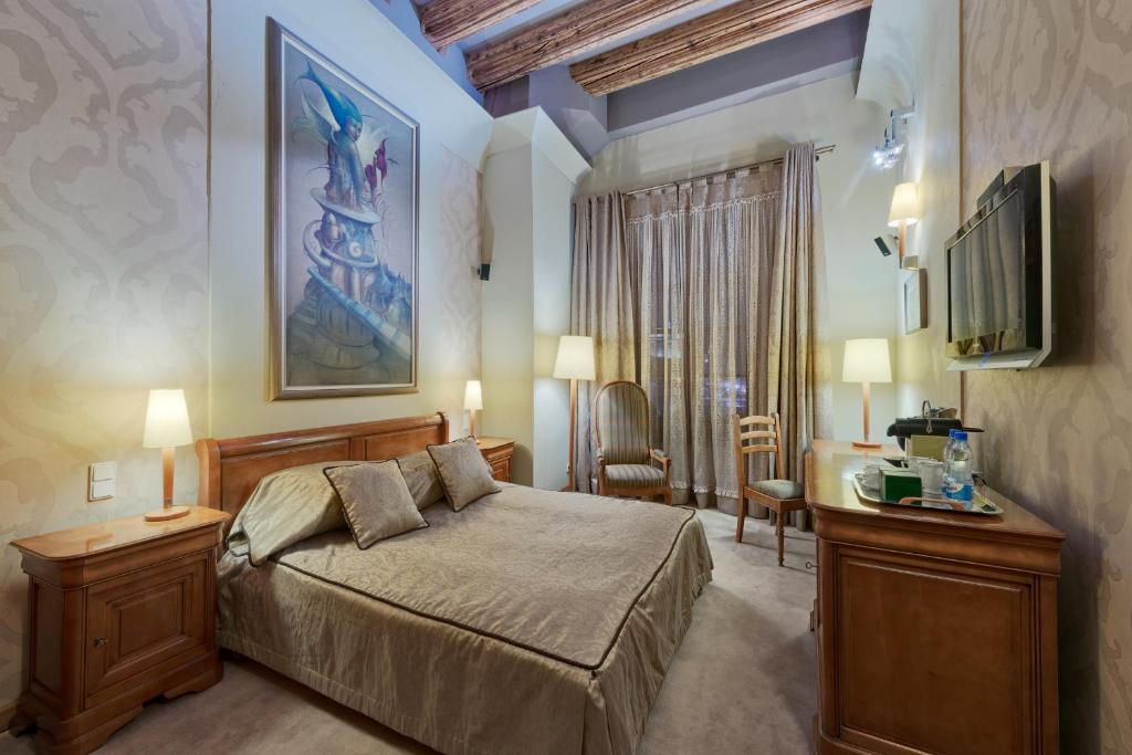 克拉科夫温特兹酒店的一间卧室配有一张床,墙上配有电视