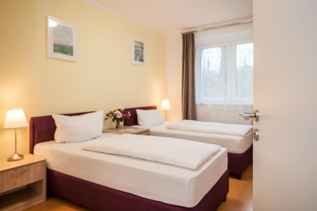 柏林柏林城市绿色酒店的酒店客房设有两张床和窗户。