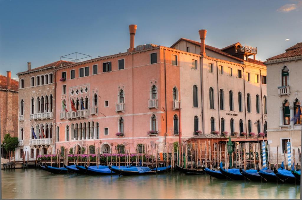 威尼斯萨赛格雷多酒店的一群在水中,在建筑物前的贡多拉