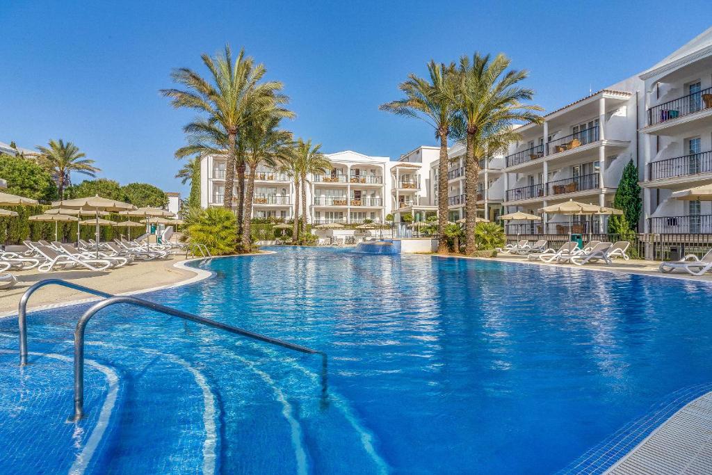 卡拉达沃因图洛特尔码头公寓式酒店的一座棕榈树和建筑的大型游泳池