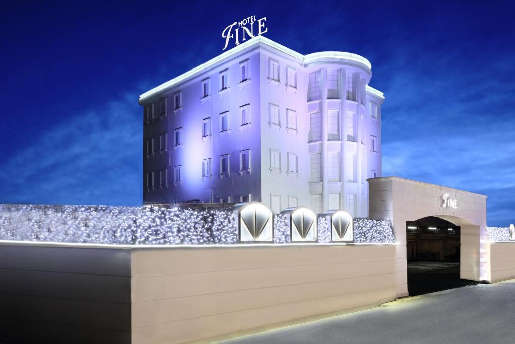 冈山Hotel Fine Garden Okayama I的白色的建筑,上面有标志