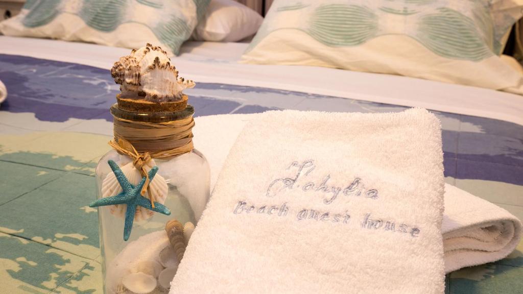 普拉提伊亚洛斯西弗诺斯Kohylia Beach Guest House的瓶子里的一条信息,带一条毛巾和一条海星