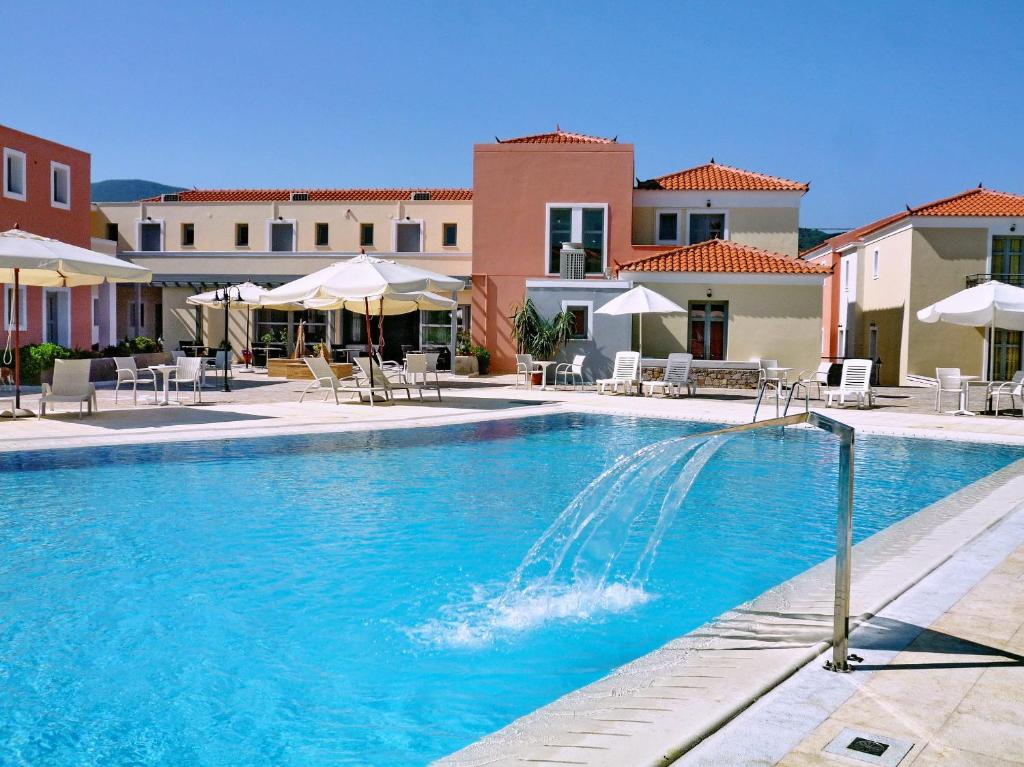 帕特雷佩特拉赛欧菲洛斯酒店的度假村内带椅子和遮阳伞的游泳池