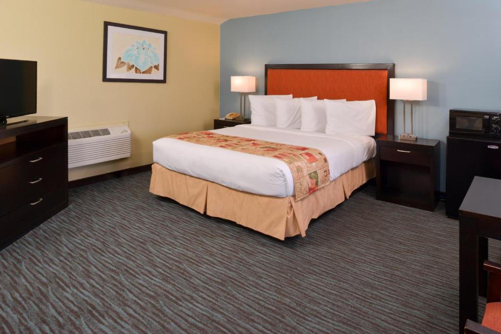 莫罗贝湾景旅馆-莫罗湾的酒店客房设有一张大床和一台电视。