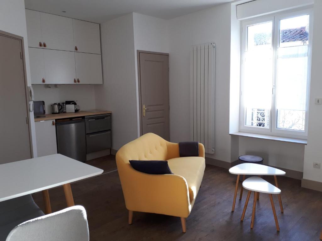 尼奥尔Un Appart en Ville的客厅配有黄色椅子和桌子