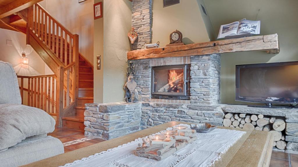 维耶拉Casa Irissa的客厅设有石制壁炉和电视。