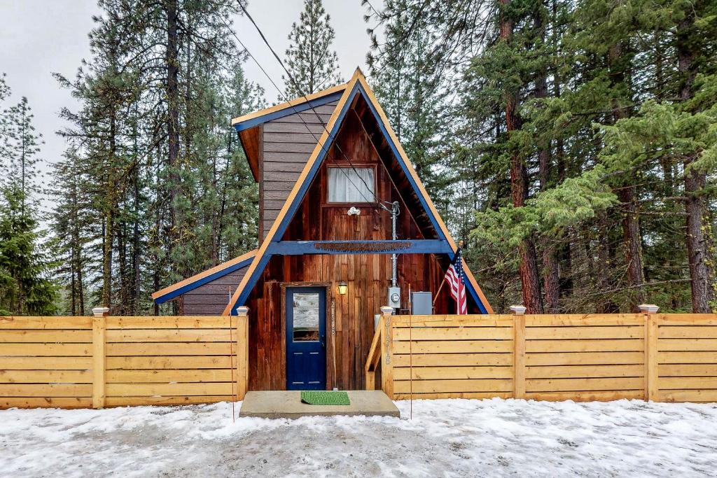 莱文沃思Copper Top Chalet的雪中带蓝色门的小小屋