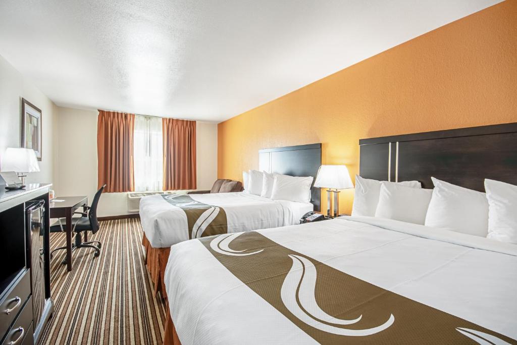 道奇城Quality Inn Dodge City的酒店客房配有两张床和一张书桌