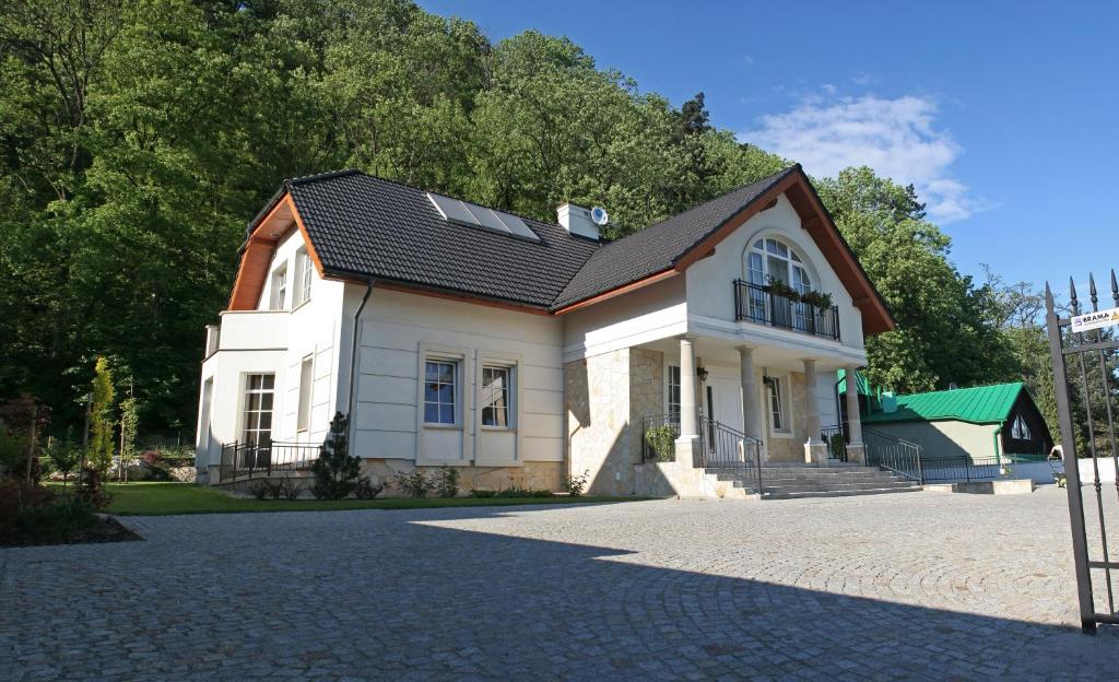 克拉科夫朱莉娅别墅酒店的车道上黑色屋顶的白色房子