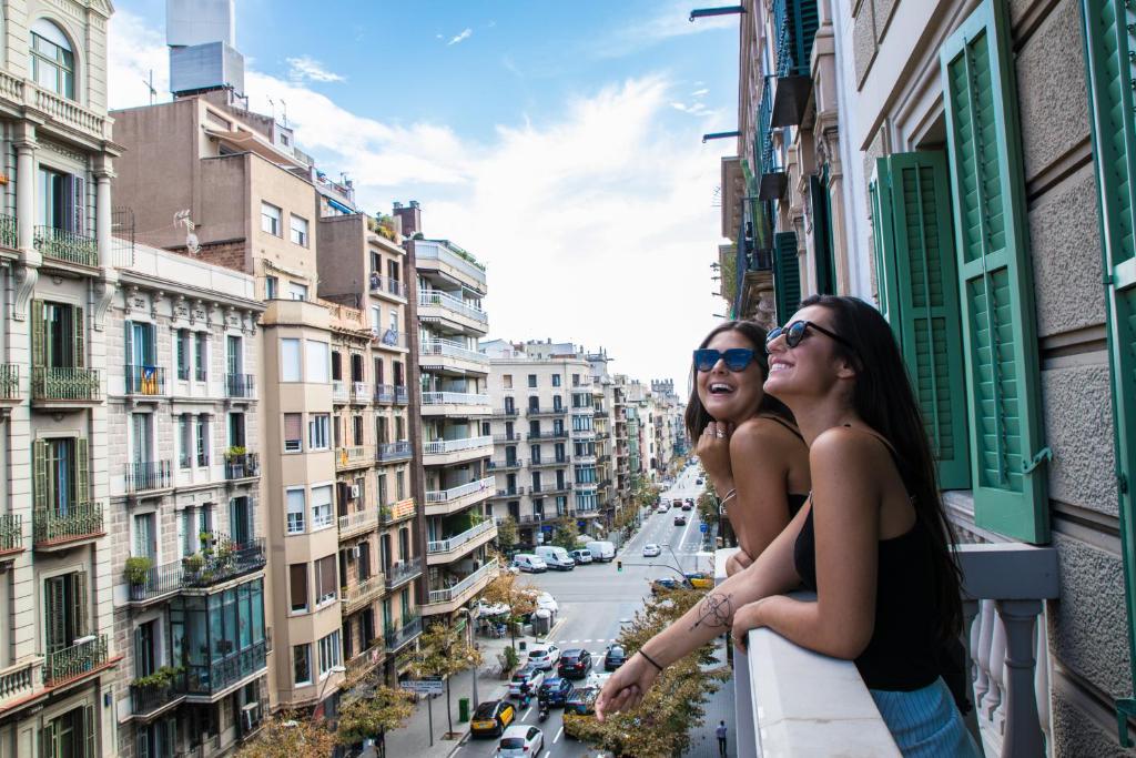 巴塞罗那Sant Jordi Hostels Rock Palace的两名妇女站在一个俯瞰城市的阳台