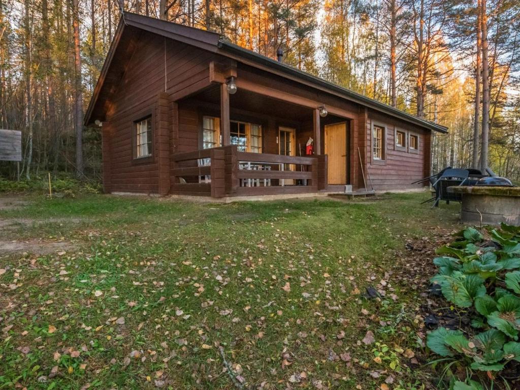VuoriniemiHoliday Home Aurinkorinne by Interhome的树林中的小木屋,带院子