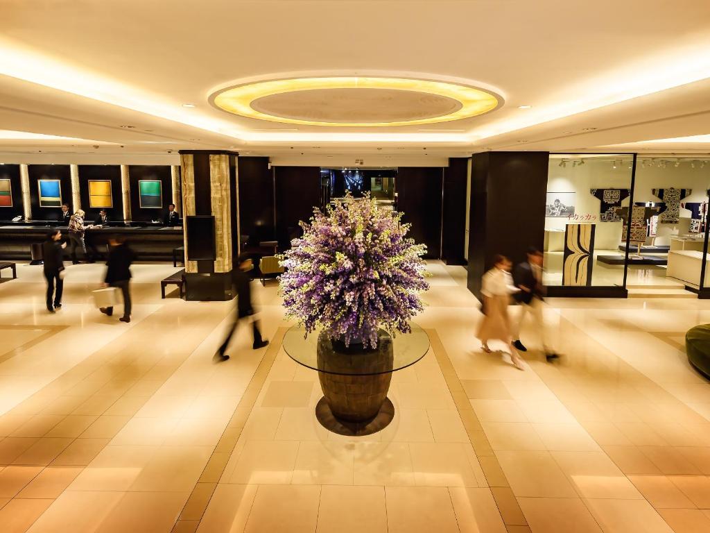 札幌札幌格兰大酒店的大堂设有大花瓶,里面装有紫色的鲜花