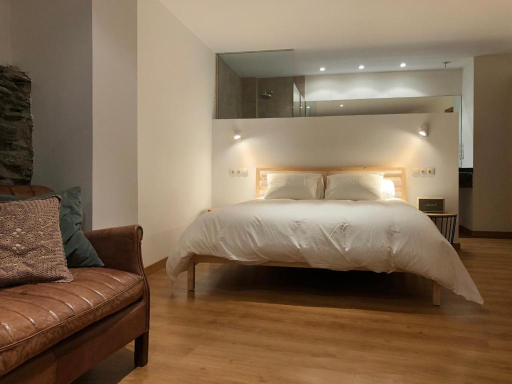 马萨纳Secret Spot Hostel的一间卧室配有一张大床和一张沙发