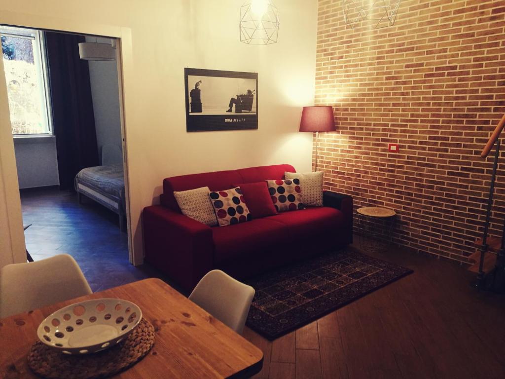 巴里Ponentino的客厅配有红色的沙发和桌子
