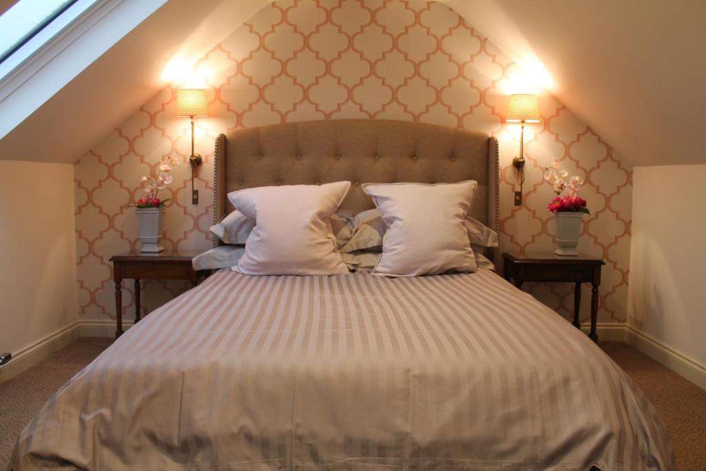 惠特比Granny's Attic at Cliff House Farm Holiday Cottages,的一间卧室配有一张带2个床头柜的大床