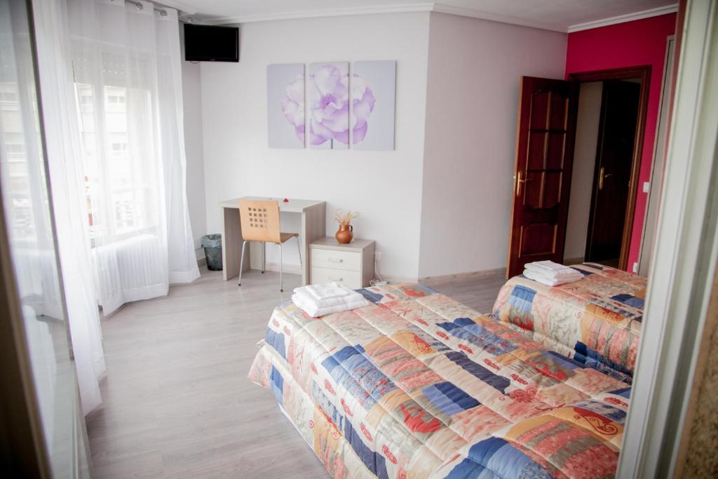 洛格罗尼奥巴赫克德尔埃布罗旅馆的一间卧室配有两张床和一张桌子